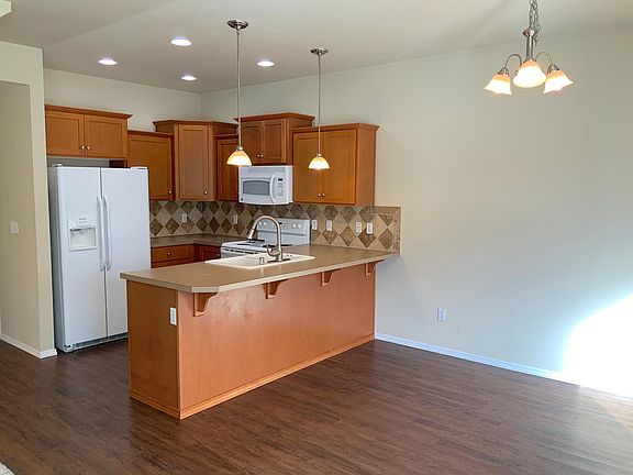 New vinyl plank flooring in kitchen, eating area, half bath, and laundry.