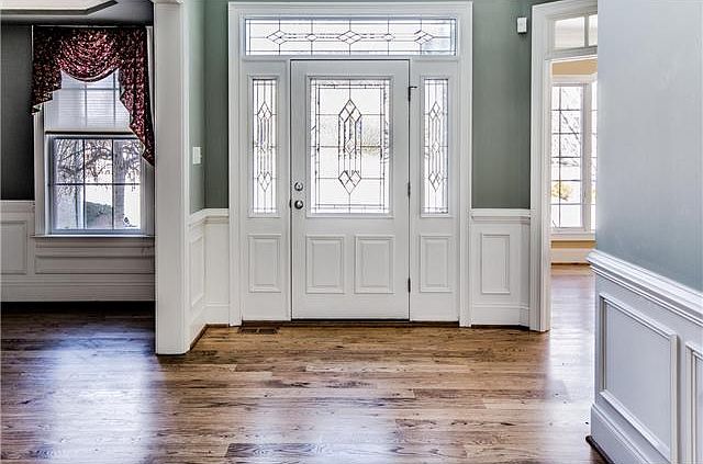 Gorgeous foyer w/ leaded glass door & wainscoting
