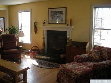 Living room with hardwood floors. Large windows to enjoy the views outside and let in lots of light.