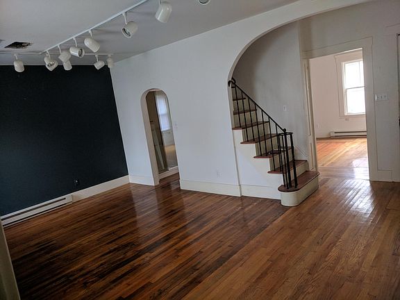 Living room and first floor bedroom (or office) and stairway to second floor with two bedrooms and full bath