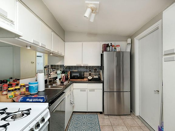 Kitchen includes gas stove, new fridge, dishwasher, and disposal