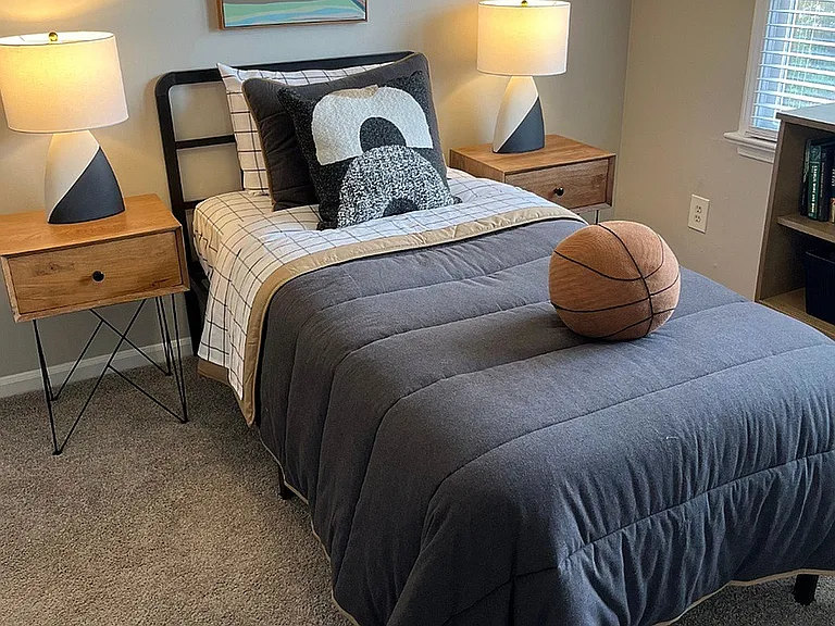 A spacious bedroom with room for both rest and a dedicated work area.