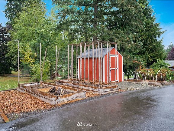 Amazing yard with RV Parking, custom paver patio with built-in firepit, detached finished studio with power, storage shed and custom-built play house!