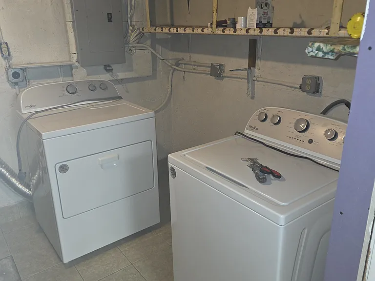 washer and dryer on the basement floor.
