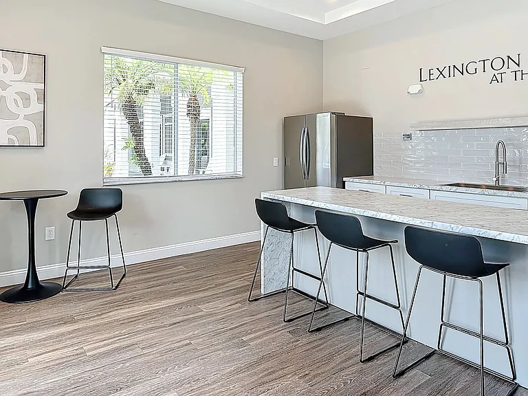 Enjoy our cabana room, featuring a sleek kitchen island, stainless steel appliances, and comfortable seating. A great place to entertain and mingle with your neighbors!