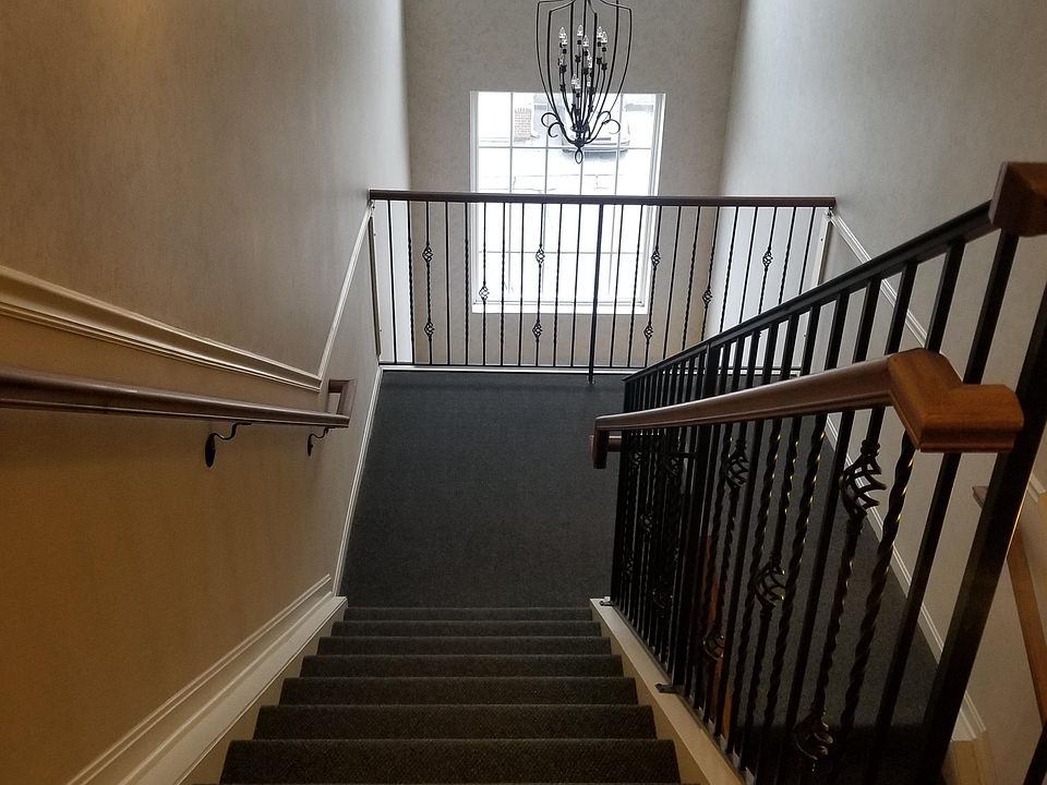 Common foyer stairway at building front door entry