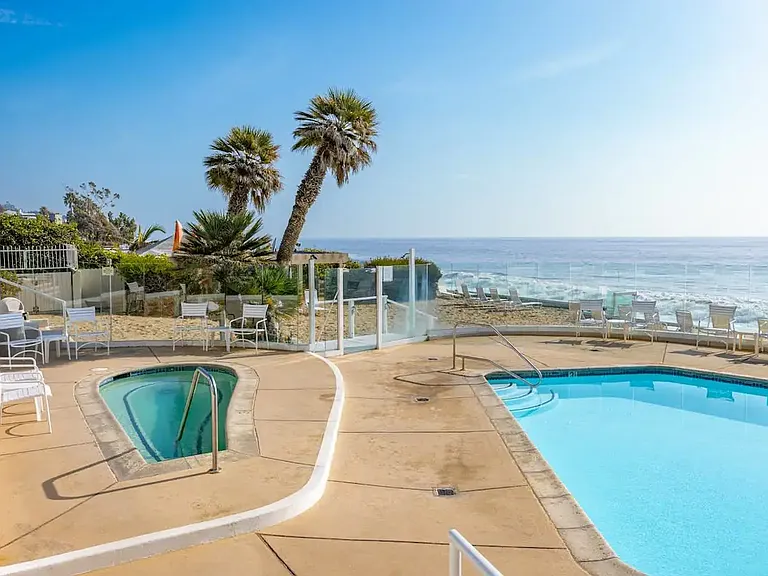Indulge in poolside bliss with the hot tub, set on a timer for your convenience, offering relaxation with a touch of coastal elegance.