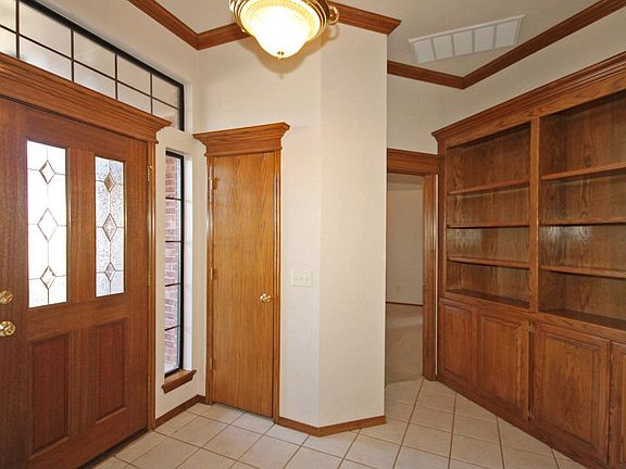 Tiled foyer opens to formal living, kitchen and family room with built-ins