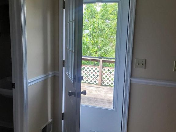 Exterior door and storm door to deck off of the kitchen.