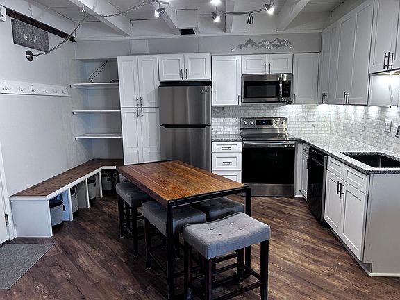 Kitchen with table and storage shown.