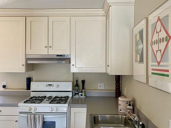 Kitchen as seen from dining room. Hallway to bathroom and bedrooms the right.