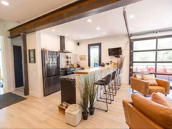 Open concept with counter seating in addition to a dining table.