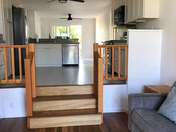 From the main entrance: small living room, kitchen, dining room, exit to backyard.