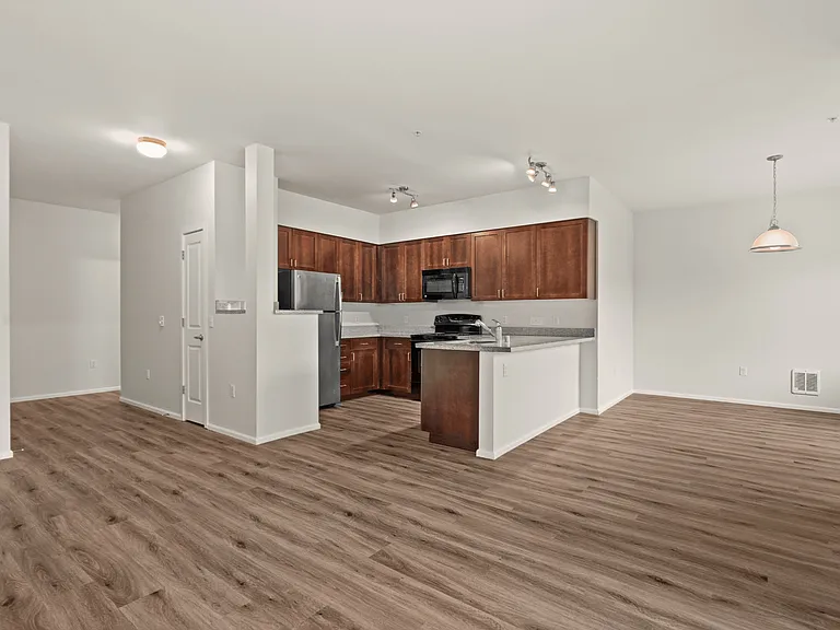 Spacious open-concept kitchen and living area at Port Landing at Fife in Fife, WA. Spacious open-concept kitchen and living area at Port Landing at Fife in Fife, WA.