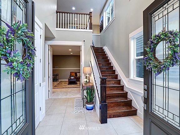 Covered front porch features these beautiful double doors. 5th Bed Guest Suite/Media Room/Bonus Room directly ahead with brand new carpet. Two walk-in closets and a full ensuite bath.  Flexible floorplan.  Garage access to your left.