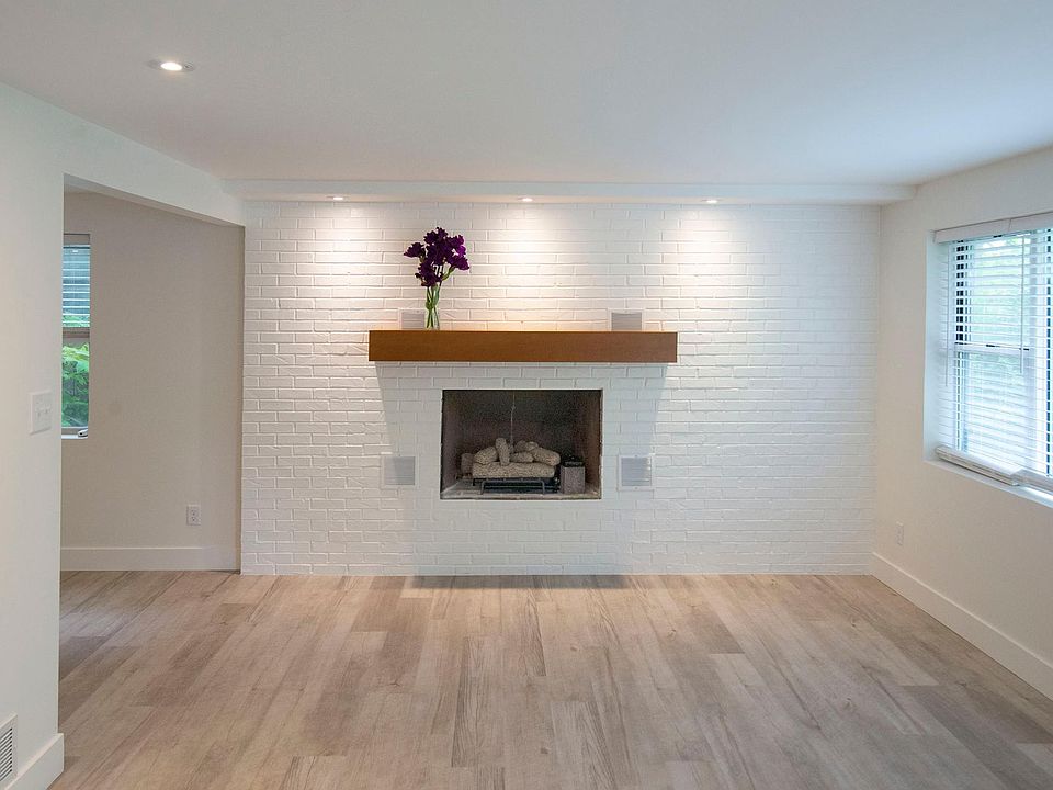 The living room includes a one-of-a-kind gas fireplace. Large windows flood the living room with light. All new flooring throughout.