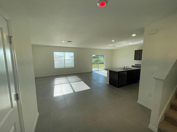 Open concept living space with all tile on first floor and brand new high-end kitchen appliances
