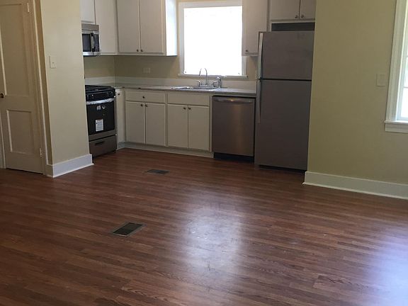 All new kitchen cabinets and appliances with open kitchen on