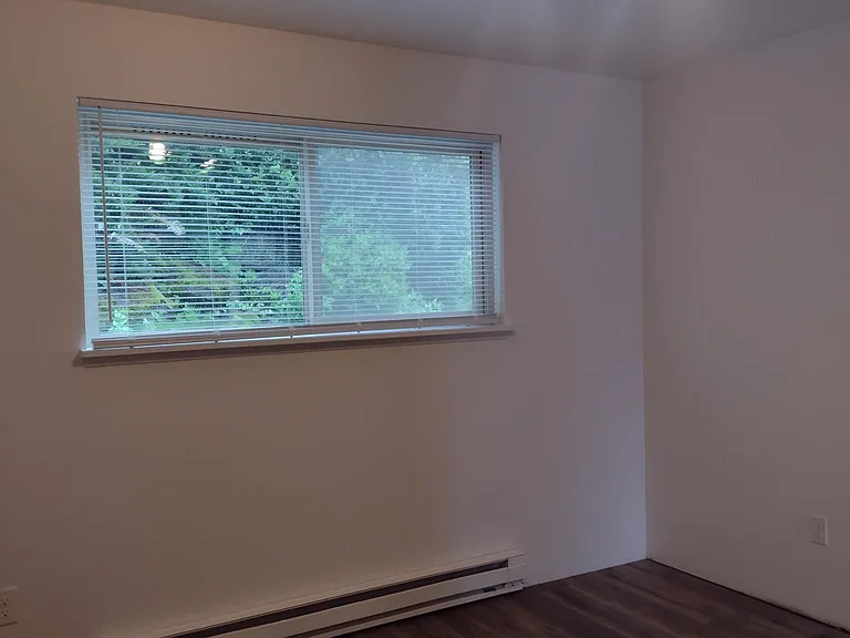 bedroom: waterproof flooring, pull down blinds, pretty greenery/rockery out back.