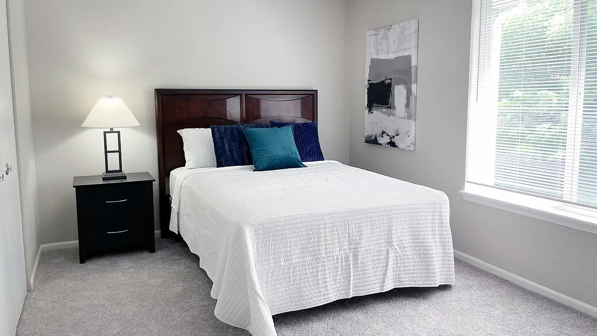 Relax in cozy bedrooms with ample space for furnishings and natural light from large windows, professionally operated by Highlands Vista Group. - Atlas North