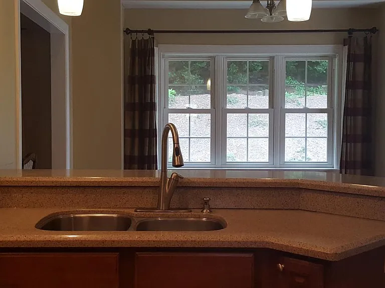Kitchen facing backyard with the adjoining breakfast bar and breakfast area