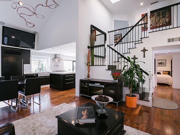 Huge open kitchen with enormous island, all the amenities, 2 dining areas, powder room, enormous panoramic windows and doors to back yard. Down stairs bedroom with private entry and full ensuite bathroom.