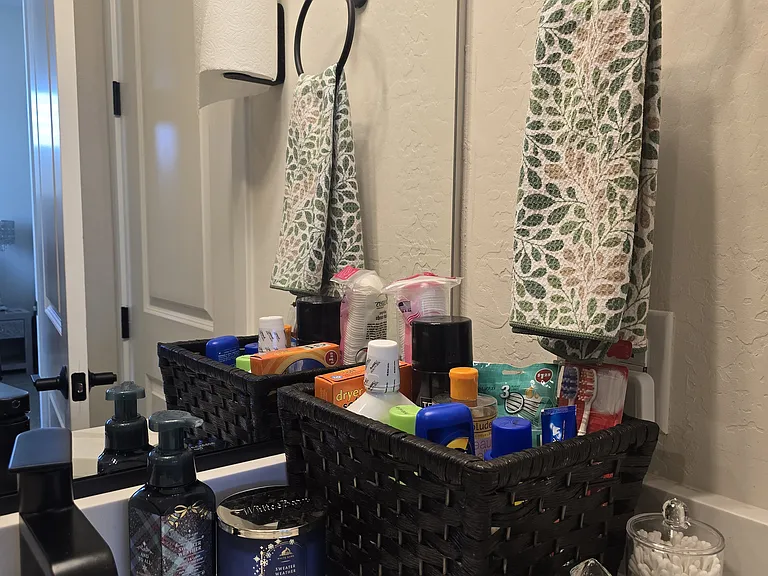 Guests receive a one-time supply of essentials: sunscreen, mouthwash, toothpaste, toothbrushes, cotton swabs, and a few personal care extras. A candle adds a soft touch, and the setup is designed to cover basic needs with ease.