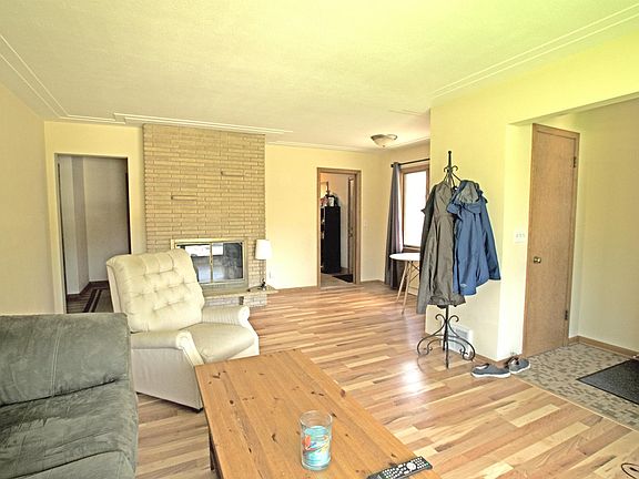 Living room with fireplace adjacent to dining area