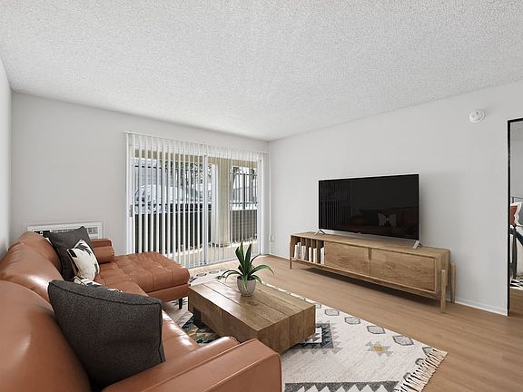 Renovated Package I living room with updated hard surface flooring (select homes)