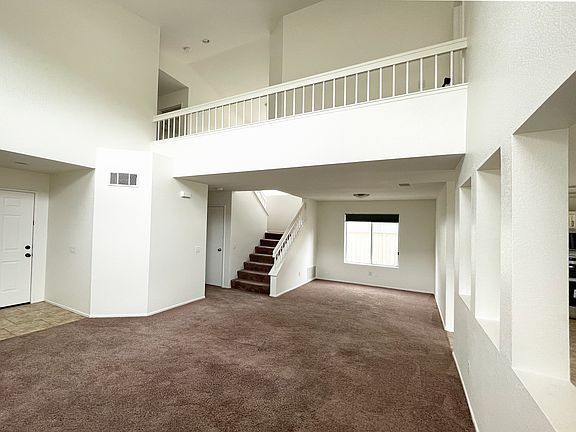 Entry, living room, dining room, stairs, view of upstairs catwalk.