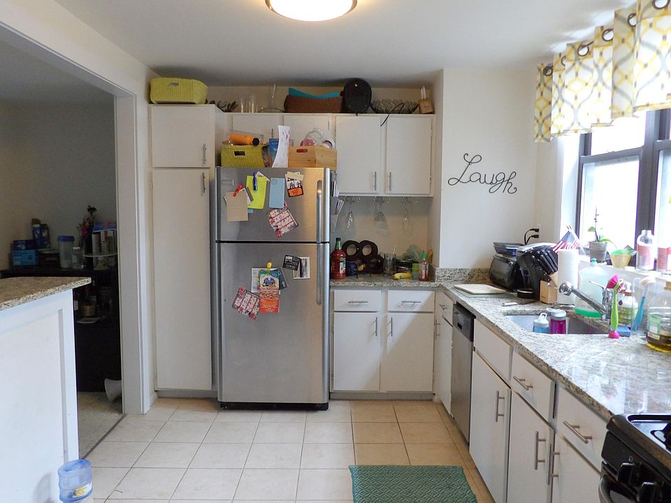 Adorable kitchen, white tile and cabinetry, stainless steel 