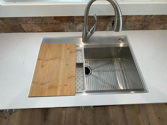 Stainless sink with built in cutting board accessories