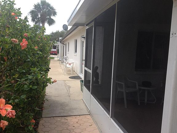 Walkway from rear of screen porch looking toward privacy gate and parking area located on Pierce Avenue