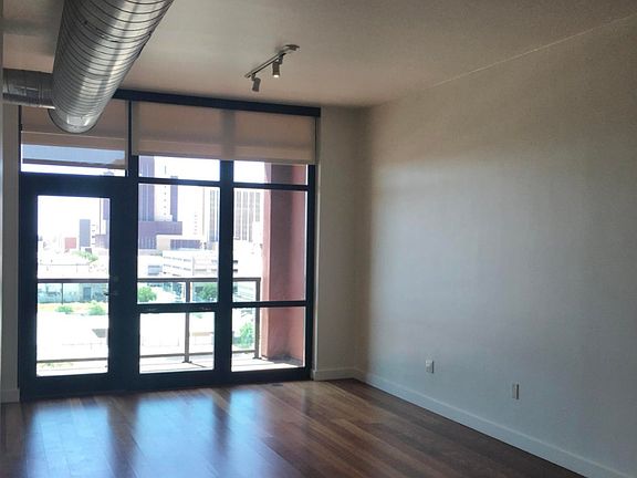 SPACIOUS LIVING ROOM WITH EXPOSED DUCTWORK