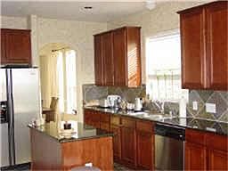    Kitchen with Granite Counter Tops, Gas range, island and beautiful 42' cabinets and slate floors.  Can view the pool and golf course from this Kitchen.