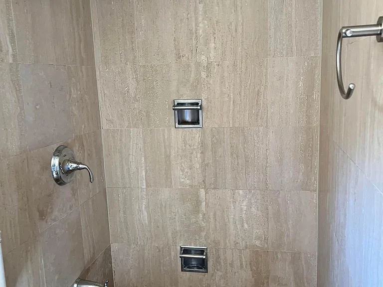 bathtub/shower of the lower-level guest bathroom