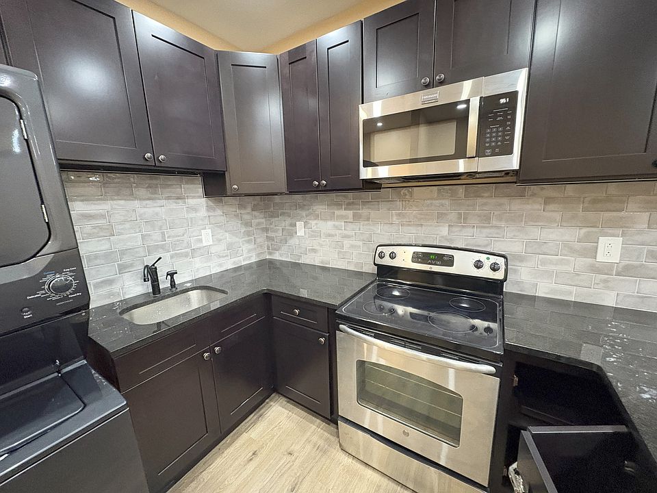 Complete new kitchen with granite countertops and stainless steel appliances.