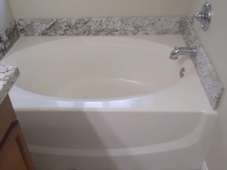 master soaker tub with matching granite surround.