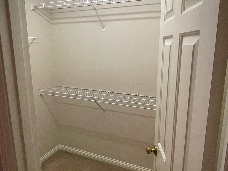 Primary bedroom walk in closet
