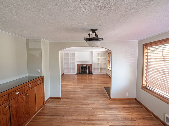 View from the kitchen of the dining room and living room. The dining room has a built-in buffet.