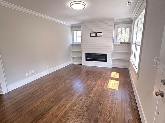 Living Room w/ built in shelves and electric fireplace