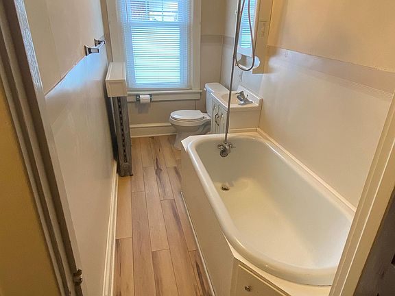 New toilet, flooring and shower head. Large cast iron soaker tub