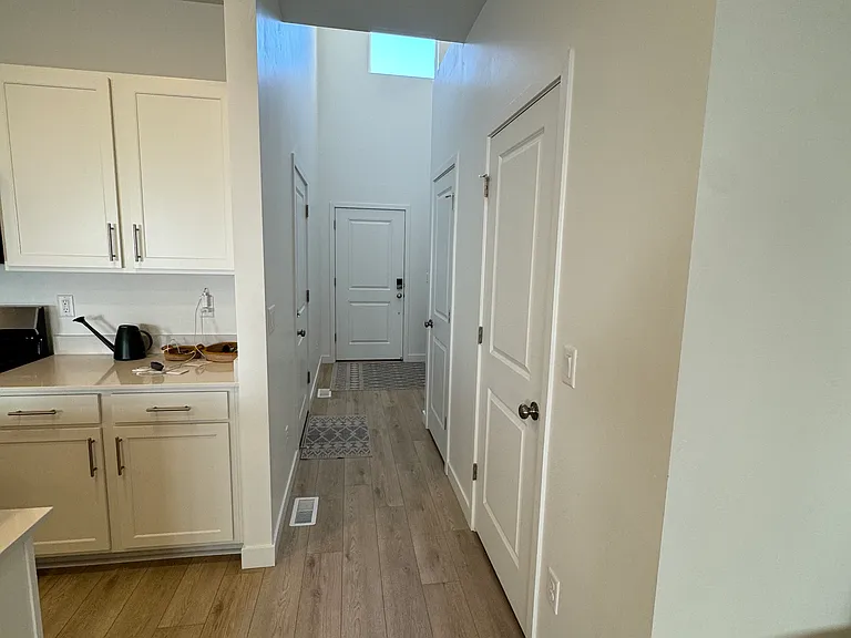 Entry hallway--coat closet, pantry, garage, and front doors