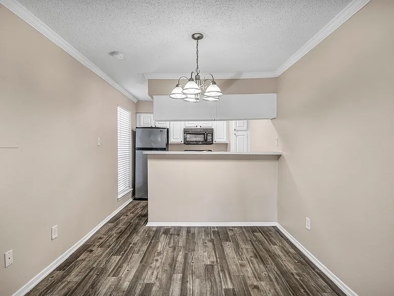 Dining area with ceiling fan and easy flow into kitchen and living spaces.