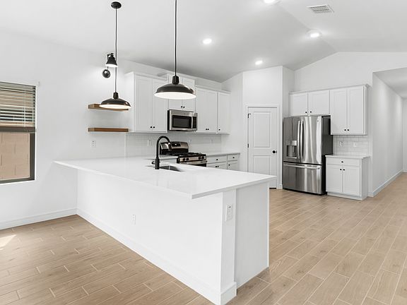 Kitchen with white cabinetry and matte black hardware