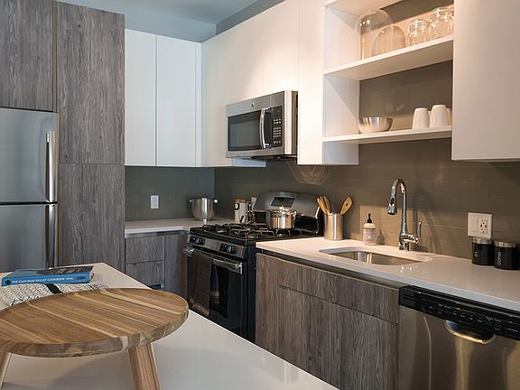 Two tone cabinetry with ample storage options including pantry