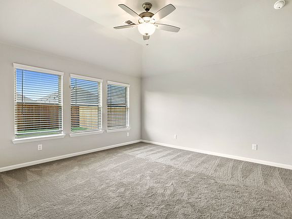 Primary bedroom in the Quartz home plan by Trophy Signature Homes - REPRESENTATIVE PHOTO