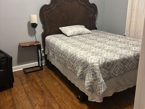 queen size bed, side lamp and side table