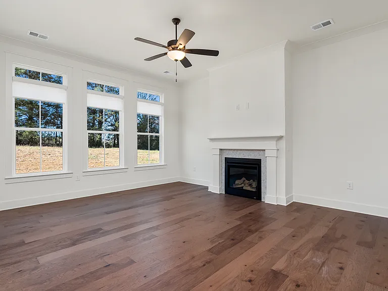 The living room with 10' ceilings and triple separate windows with transom widow extending even more light into the space.