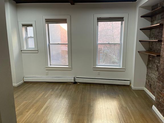 Larger of the two upstairs bedrooms looks out to the massive private backyard.